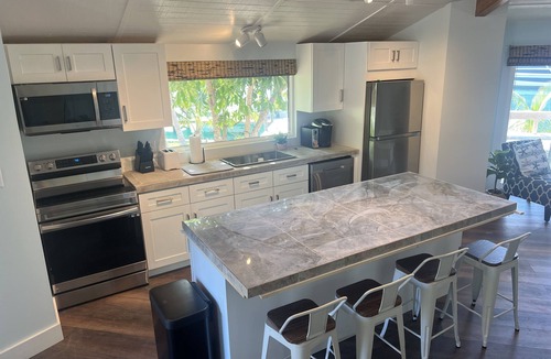 Treasure Cay House | Big Yellow House with Deep Water Dock with Power, and Tesla Backup Power.
