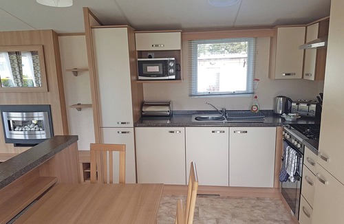 Kilcreggan House | Contemporary 12ft-wide caravan with one double and two twin.