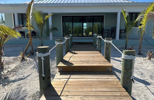 Treasure Cay House | Deep water Canal front home w/dock across the street from the beach.