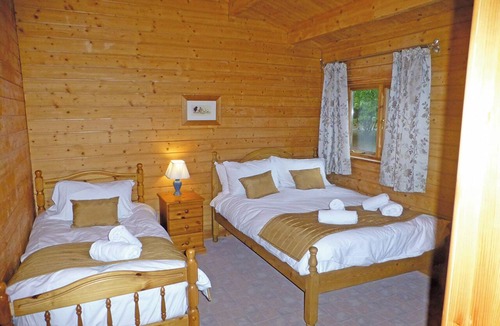 Cullompton Ski Chalet | Spacious timber lodge with one double and one single in one room.