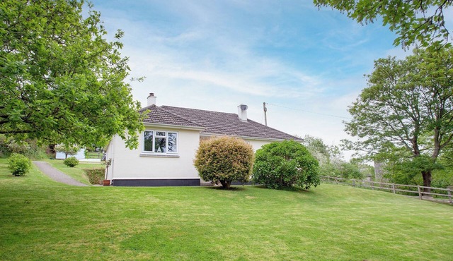 A spacious bungalow for four overlooking a wooded valley with its own garden.