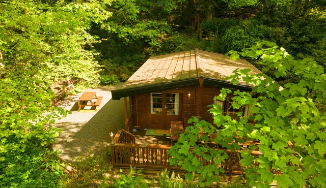 Luxury pine log cabin positioned within the mountains of the Lake District