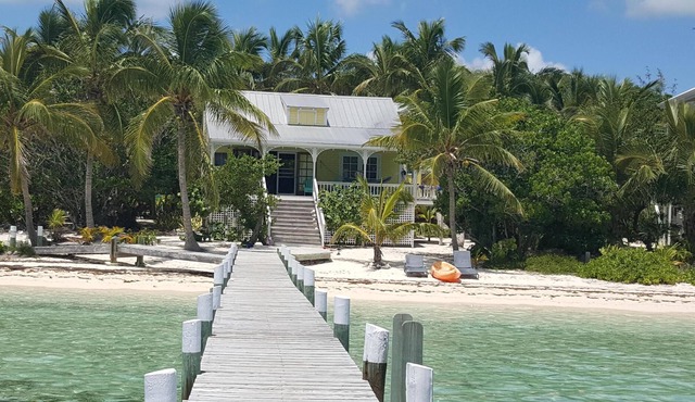 Sandy beachfront paradise with dock and a/c bedrooms at Green Bananas Cottage