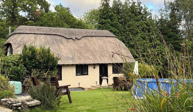 Thatched cottage with hot tub, games room, and garden – ideal for romantic breaks or family escapes